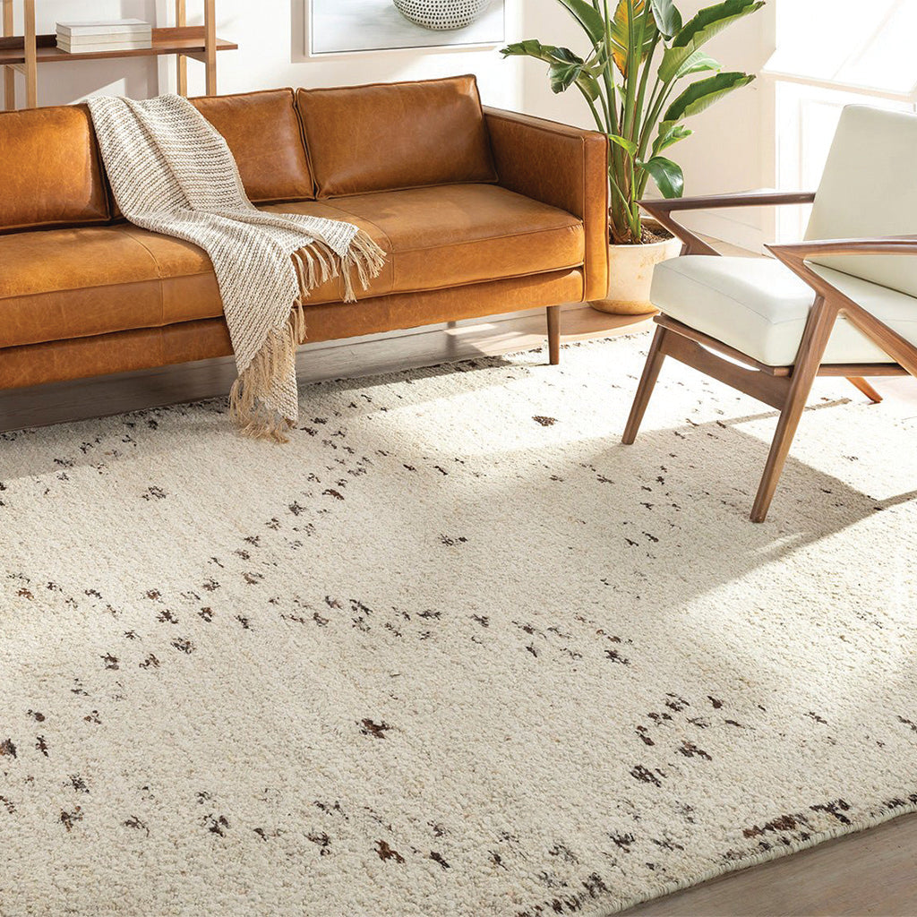 Orange chair on area rug with desk