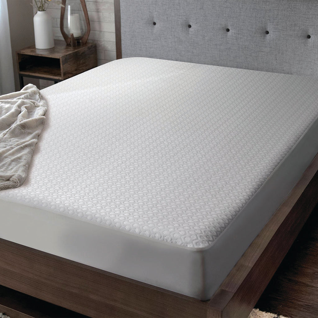 Mattress protector on upholstered bed